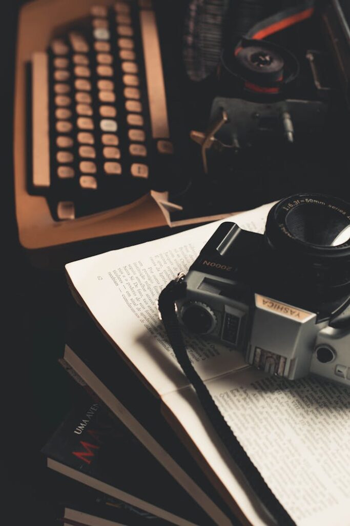 Retro scene featuring a vintage camera and typewriter on an open book.